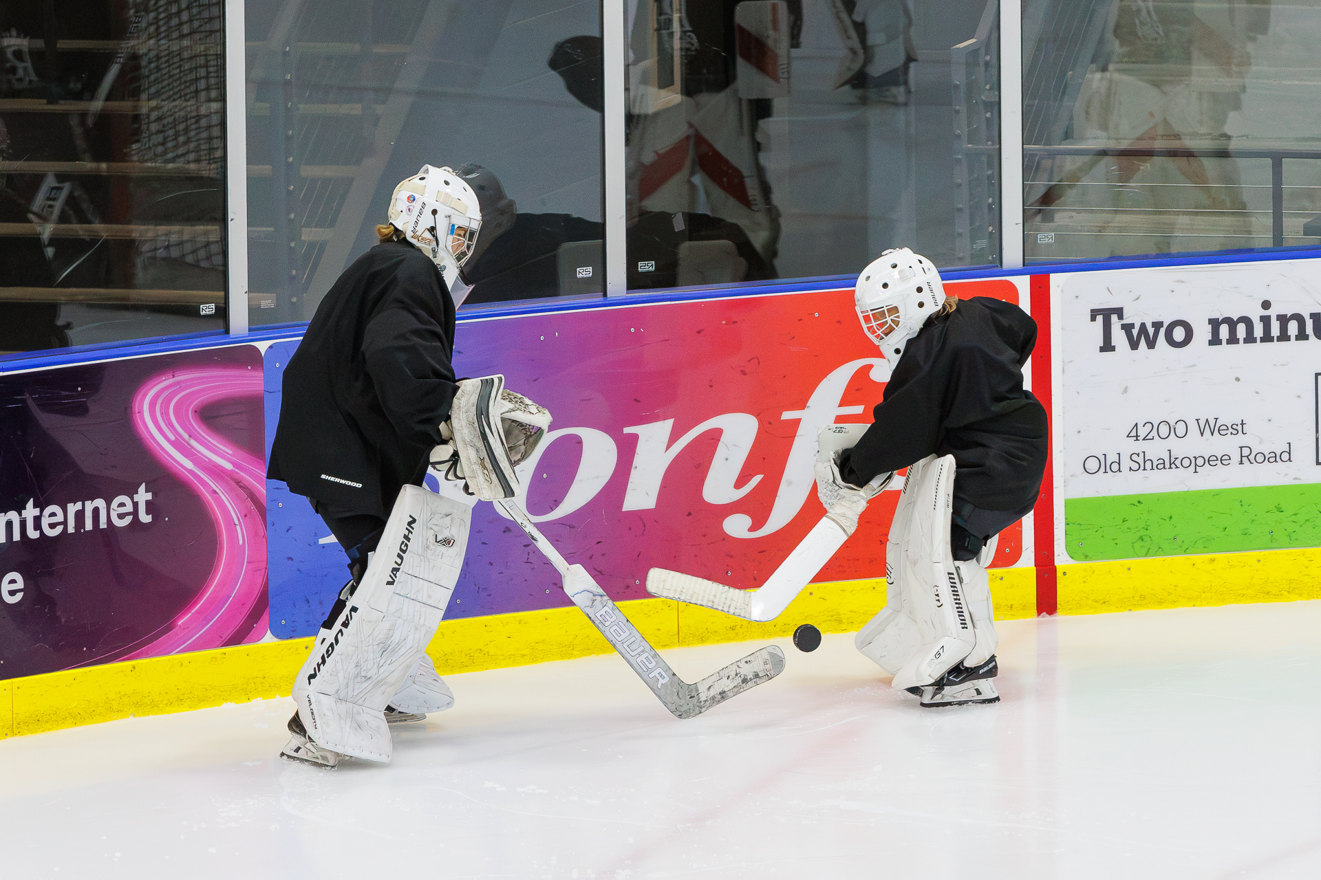 Two goalies working through a puck drill