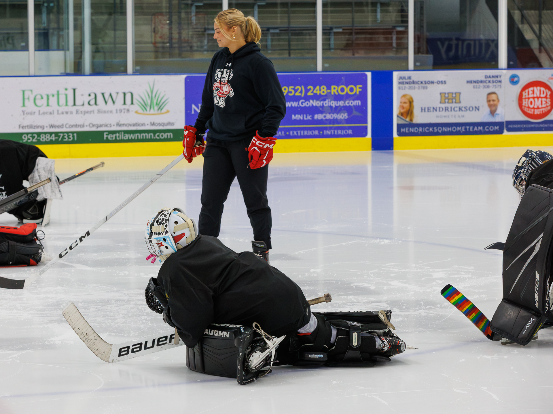 Coach observing goalies during practice